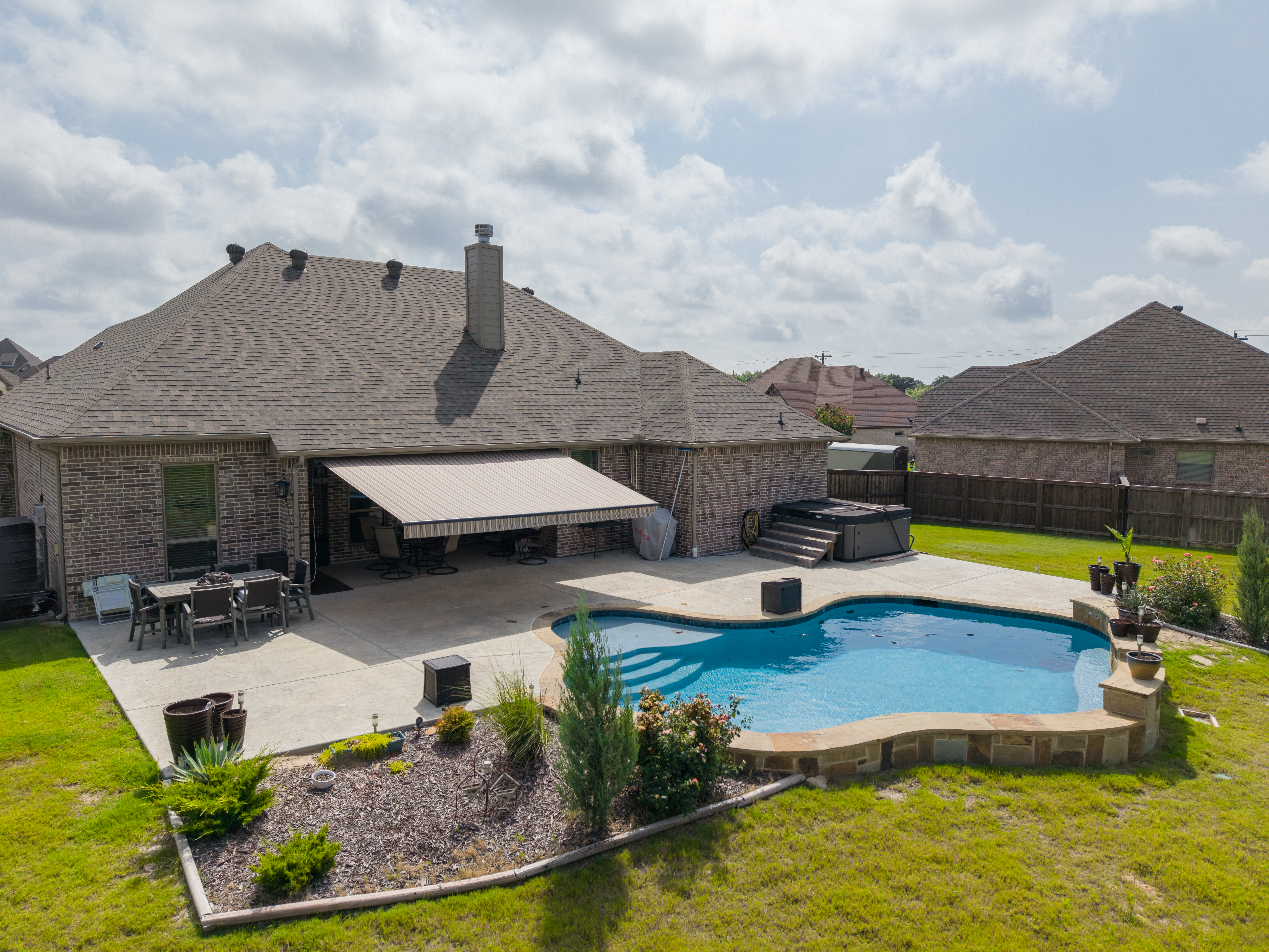 Awning-Residential-Patio-Pool-Brick-House-Extended-Aerial-View