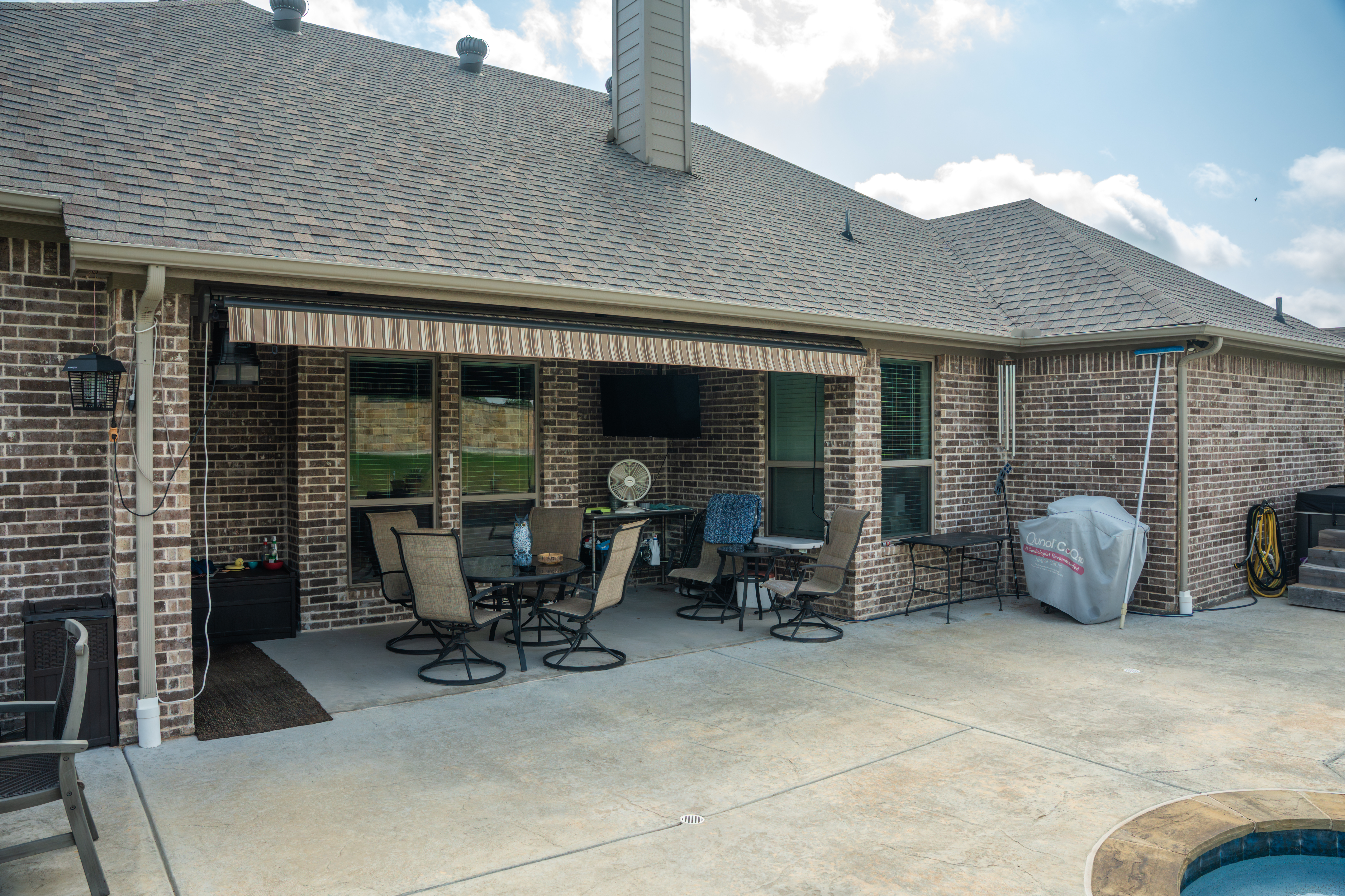 Awning-Residential-Patio-Pool-Brick-House-Retracted-View